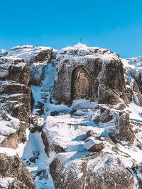 Snow covered rocks against clear blue sky - star lady