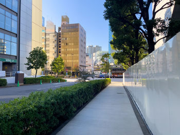 Canal amidst buildings against clear sky