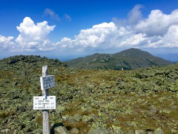 Scenic view of mountains against cloudy sky