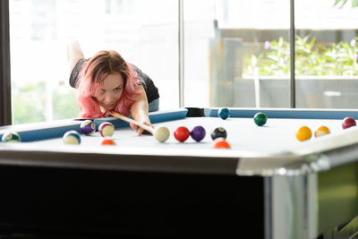 Woman playing with ball on table