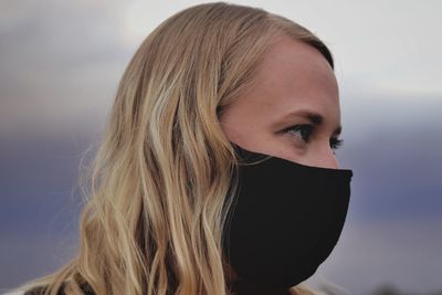 Close-up portrait of a beautiful young woman wearing a mask