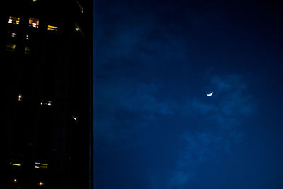 Low angle view of illuminated moon in sky