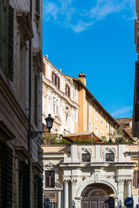 Low angle view of buildings in town against sky