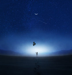 Low angle view of airplane flying against sky at night