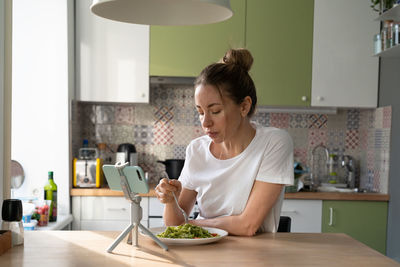 Young woman using smart phone at home