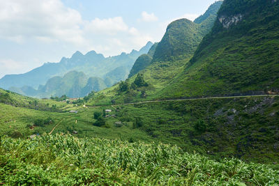 Scenic view of land and mountains against sky