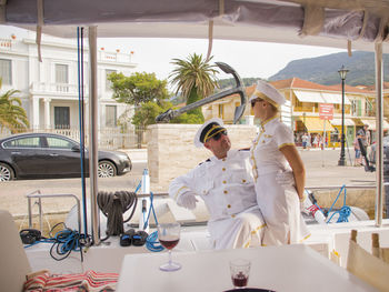 Boat captain embracing woman in ship