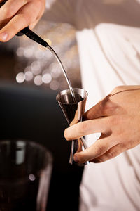 Midsection of man holding wineglass