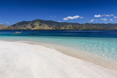 Scenic view of sea against blue sky