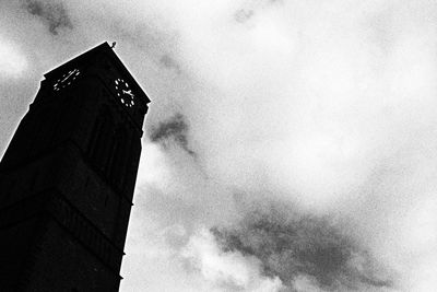 Low angle view of building against cloudy sky