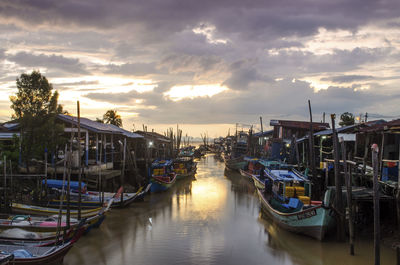 Boats in harbor at sunset