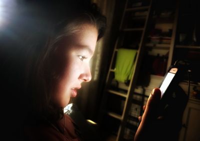 Close-up of teenage girl using mobile phone