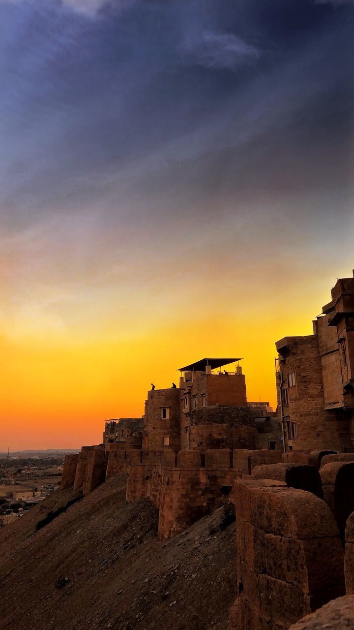 VIEW OF OLD BUILDING AGAINST SKY DURING SUNSET