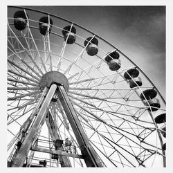 Low angle view of ferris wheel against sky