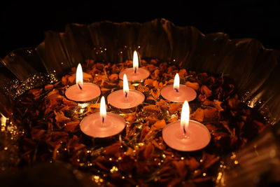 Close-up of illuminated candles on table