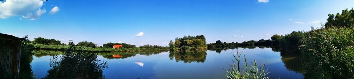 Panoramic view of lake against blue sky