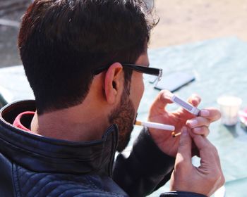 Close-up of man igniting cigarette