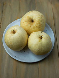 High angle view of apples in plate on table