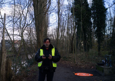 Full length of man standing in forest