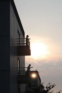 Low angle view of built structure at sunset