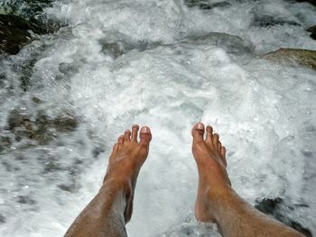 Low section of feet above flowing water