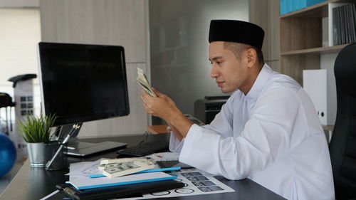 Businesswoman working at desk in office