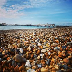 Pebbles on beach against sky