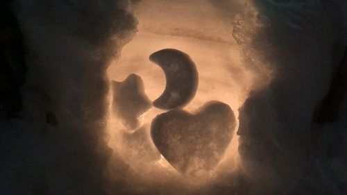 Close-up of heart shape against sky at night