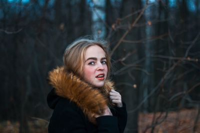 Portrait of woman in forest during winter