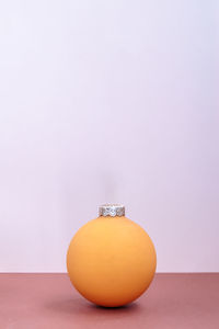 Close-up of orange fruit against white background