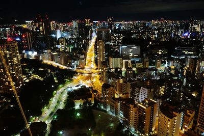 Aerial view of illuminated buildings in city at night