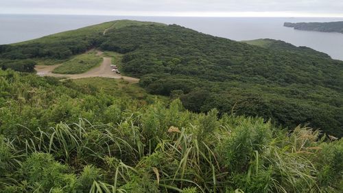 Scenic view of sea and mountains against sky