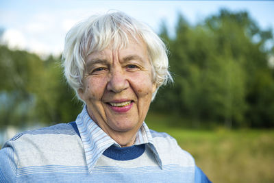 Portrait of senior woman standing at park