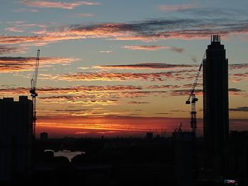 Silhouette of buildings against cloudy sky