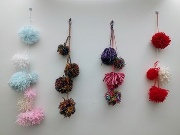 Close-up of decoration made of wool against wall - handicrafts