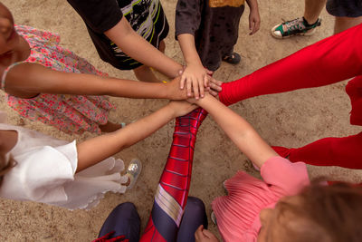 Group of kids stacking hands together