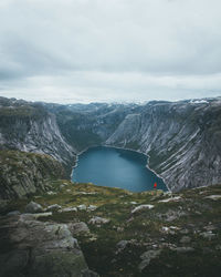 Scenic view of lake amidst mountains against sky