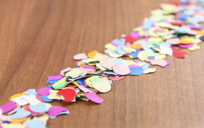 Close-up of multi colored confetti on table