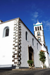 Low angle view of church against blue sky