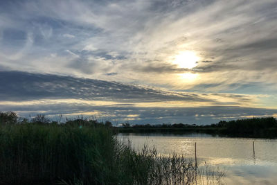 Scenic view of lake against sky during sunset