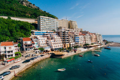 Panoramic view of sea and buildings against sky