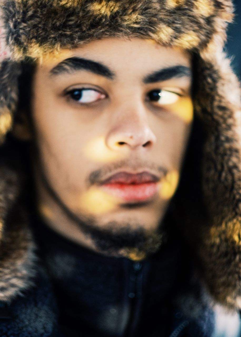 CLOSE-UP PORTRAIT OF SERIOUS YOUNG MAN