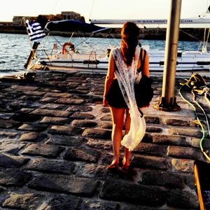 Full length of woman standing at beach