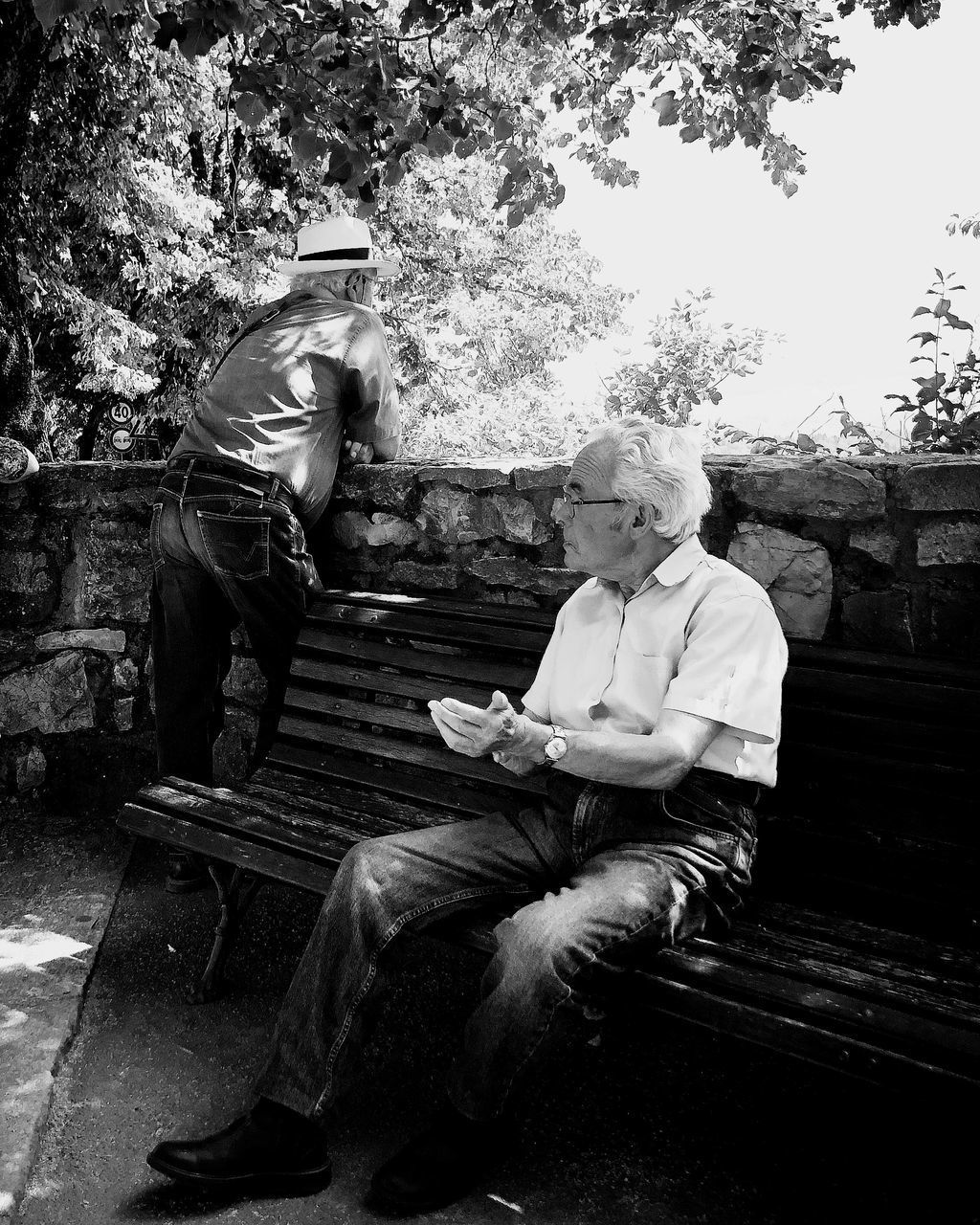 MAN SITTING ON BENCH