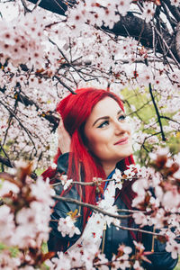 Portrait of young woman holding plant