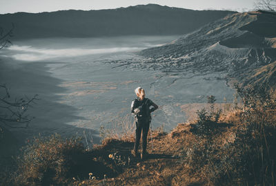 Rear view of woman standing at mt bromo