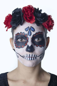 Portrait of young woman with red flower