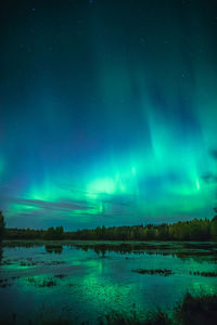 Scenic view of lake against sky at night