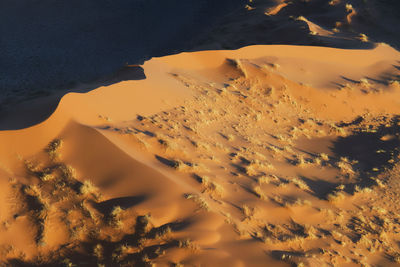 Scenic view of desert against sky during sunset