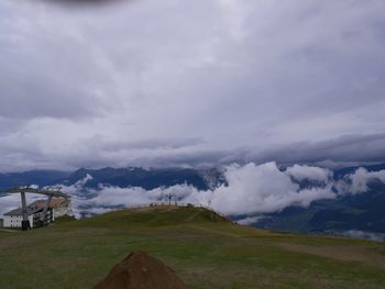 Scenic view of mountains against cloudy sky